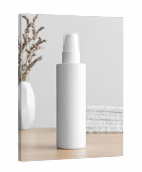 White cosmetic lotion bottle mockup with a lavender and towels on the wooden table.