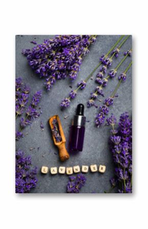 A bottle of essential oil with fresh blooming lavender twigs. Top view. Free space for text.