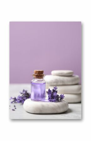 Stones, bottle of essential oil and lavender flowers on marble table