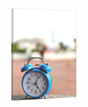 Blue vintage alarm clock  on compound wall