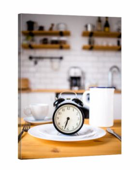 intermittent fasting concept alarm clock on kitchen table