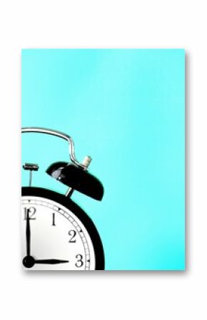 Black retro alarm clock at 3 three o clock on a blue background with copy space to add text 3am 3pm