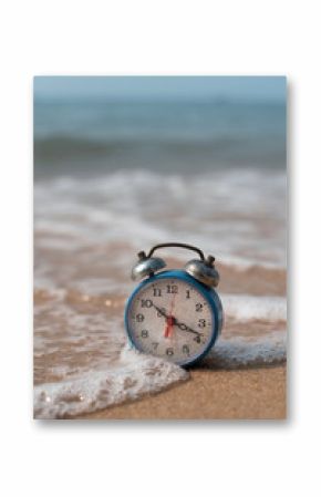 alarm clock on sand beach