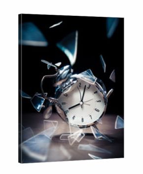 broken alarm clock with shattered glass on a dark background