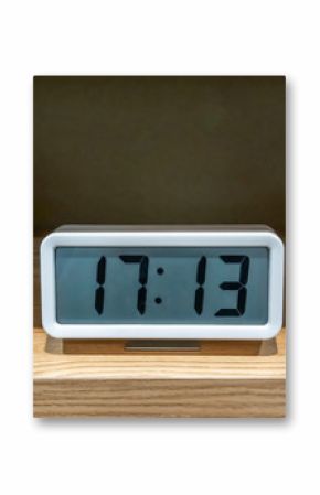 White pocket digital clock on wooden shelf
