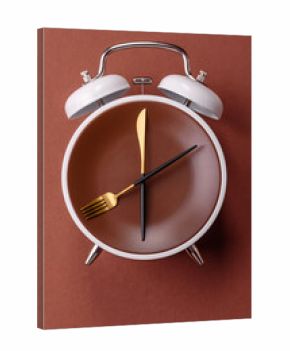 Empty plate with devices in the form of clock hands as a conceptual background for lunch time