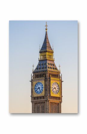 Big Ben clock tower glowing in golden sunset light, London