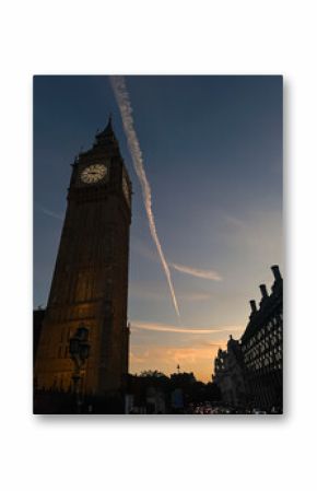 Elizabeth Tower and Big Ben clock face lit up at night in London, UK.