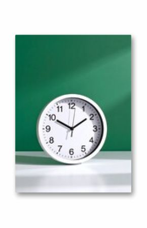 White clock on a green background