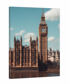 Majestic big ben clock tower against blue sky and white clouds, a symbol of london and england