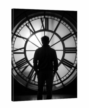 silhouette of a man with a clock