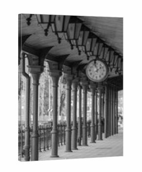 old historic railway station, passage between platforms, wooden architecture of the railway station, old clock, black and white photo