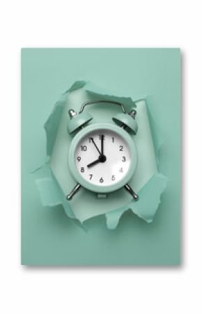 Classic round alarm clock in the paper hole with torn sides. Through paper. Ripped hole. Deadline concept.