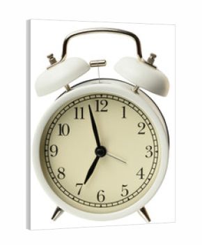 Round white metal alarm clock on isolated background