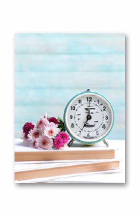 Beautiful flowers with clock and book