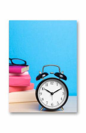 Back to school background with books and alarm clock