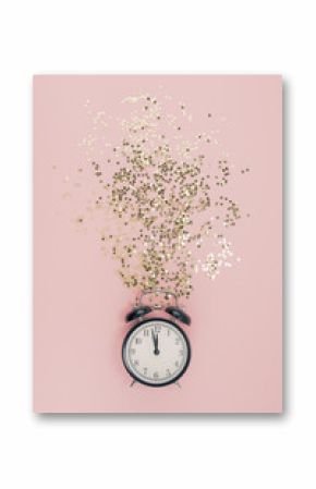 New Year concept. Alarm clock with golden confetti