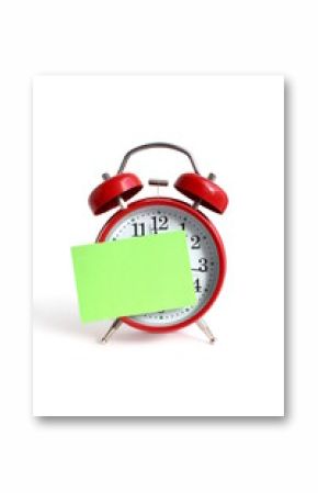 On a white background there is an alarm clock with a sticker for an inscription.