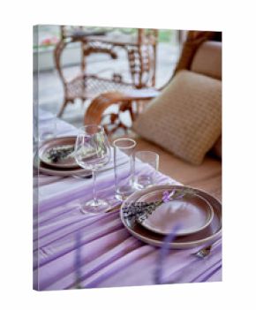 Table setting with sparkling wineglasses, plate and cutlery on table, copy space. Place set at wedding reception. Table served for wedding banquet in restaurant