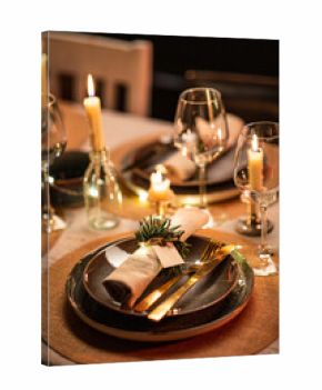 winter holidays, dinner party and celebration concept - close up of scandinavian christmas table serving with burning candles at home at night