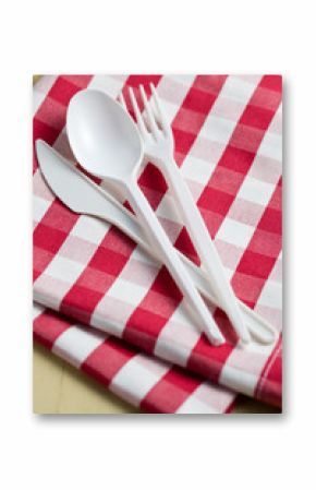 plastic cutlery on checkered tablecloth