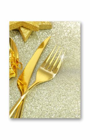 Christmas golden cutlery and ornaments on festive background