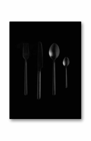 still life of black cutlery on black background, fork, knife, spoon, teaspoon 