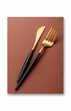 Knife and fork, cutlery on a brown dining table