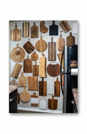 Kitchen with a wall covered in cutting boards 