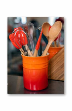 Ceramic utensil holder with scrapers, whisk and wood spoons 