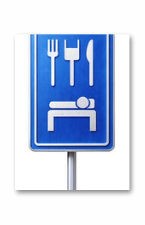 A blue road sign featuring icons of cutlery and a bed, indicating the availability of dining and lodging facilities. Minimalist design ideal for travel themes.