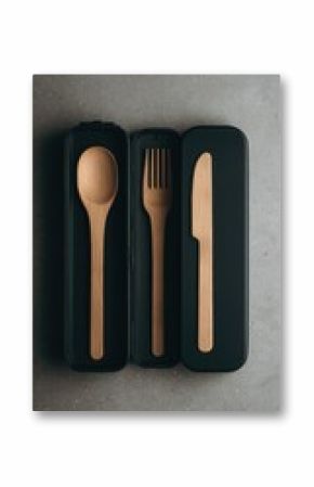 Dark gray case holds light brown wooden cutlery