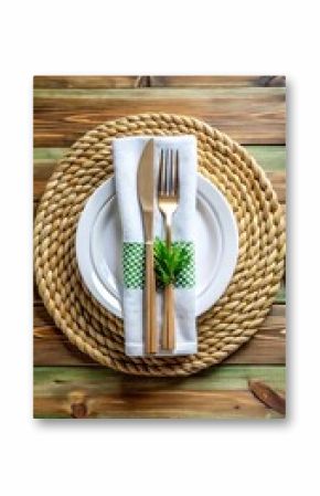 Elegant table setting with gold cutlery and green napkin decoration