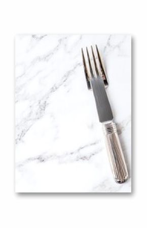 Elegant silver fork on marble surface