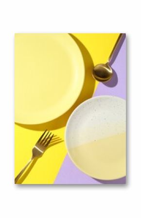 Stylish plates and cutlery on color background, flat lay