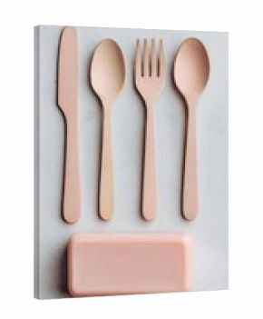 Pastel pink and beige eco-friendly cutlery set on a light gray surface.  A bar of matching soap is below