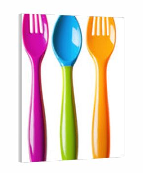 Three brightly colored plastic utensils spoon and forks isolated against a transparent background