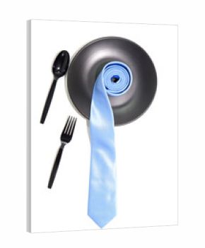 Necktie rolled on black plate with cutlery set together closeup view on white background, Food concept background photography 