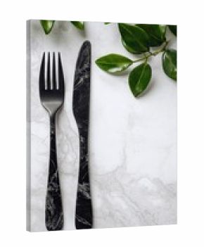 Black cutlery on white marble