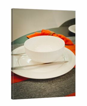 Table setting festive table. White plate with napkins and cutlery on the table. Vertical photo.
