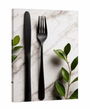 Black cutlery on marble with greenery (2)