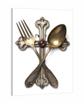 Antique silverware crosses atop a white background.  A fork and spoon, ornate with detailed carvings, are arranged in a cross shape.  A small, jewel-toned red gemstone is centered on the cross