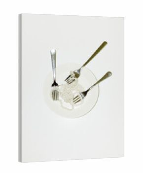 Conceptual image of eating jewellery pearls with fork cutlery & plate