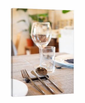 Table set with modern cutlery and glassware