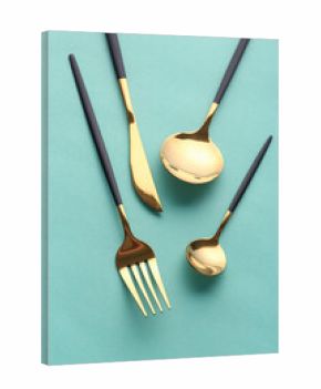 Stylish cutlery on green background