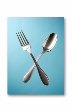 Fork and one spoon floating or flying isolated on light blue background