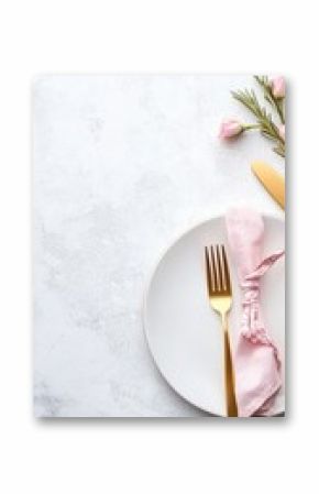 Golden cutlery and a yellow napkin accompany an empty plate on a gray marble table, evoking a refined dining atmosphere ready for service