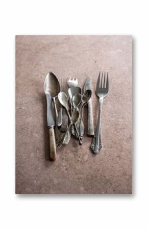 Collection of Vintage Silverware on a Textured Surface