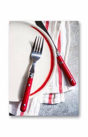 Close-up overhead view of a red place setting on a folded tea towel