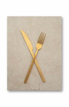 Set of golden metal cutlery on stone table